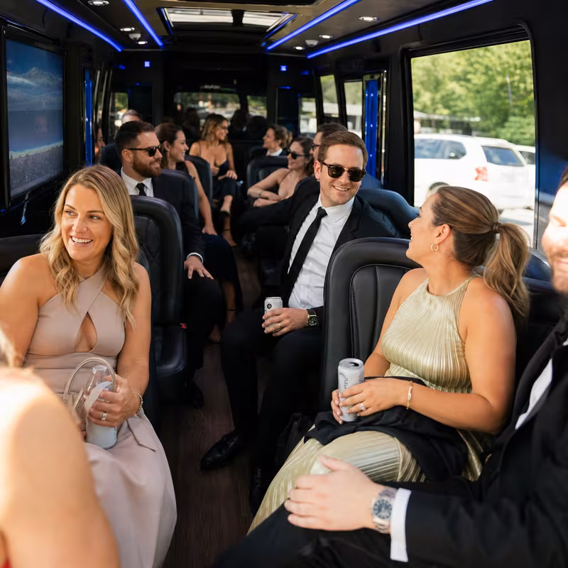 Wedding guests seated inside a Frederick party bus