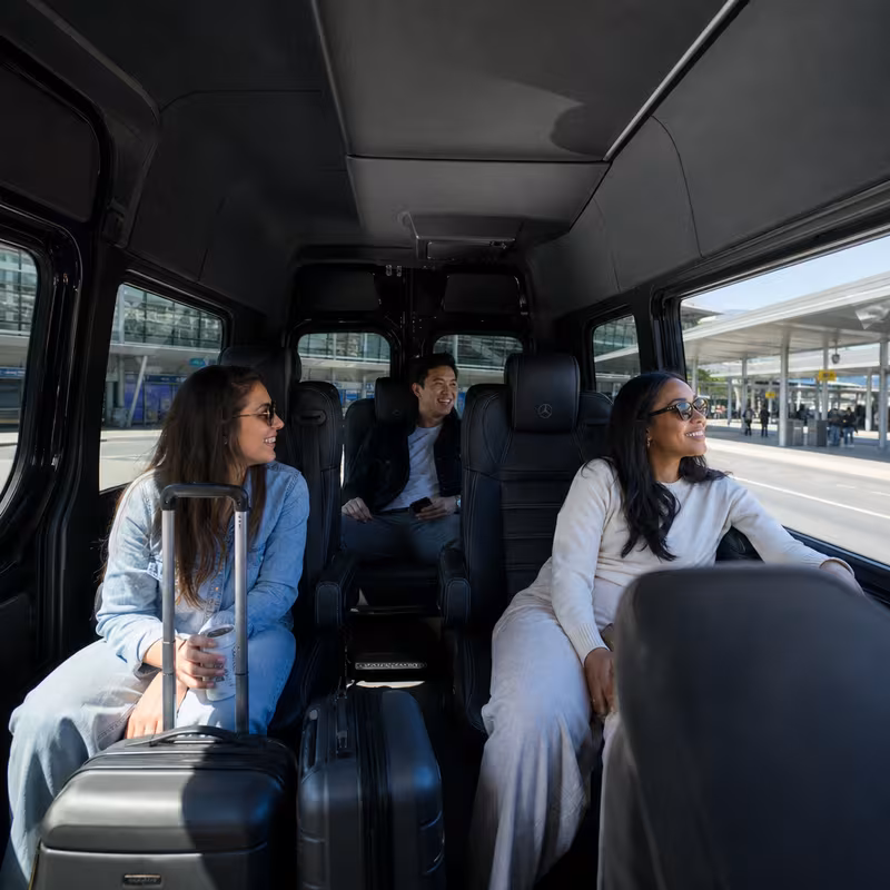 Passengers loading luggage while boarding an Frederick group shuttle