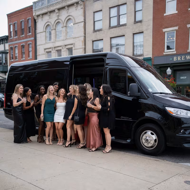 Group boarding a white charter bus for Bachelor & Bachelorette Transportation transportation in Frederick