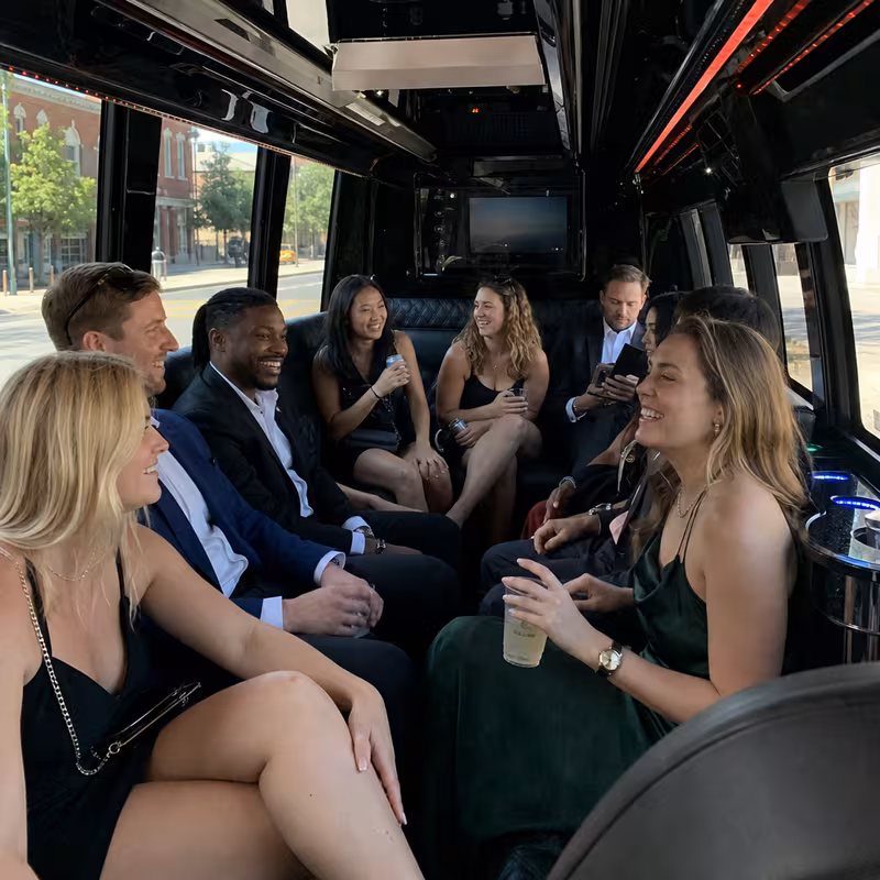 Party bus interior with wraparound leather seating and LED lighting in Frederick