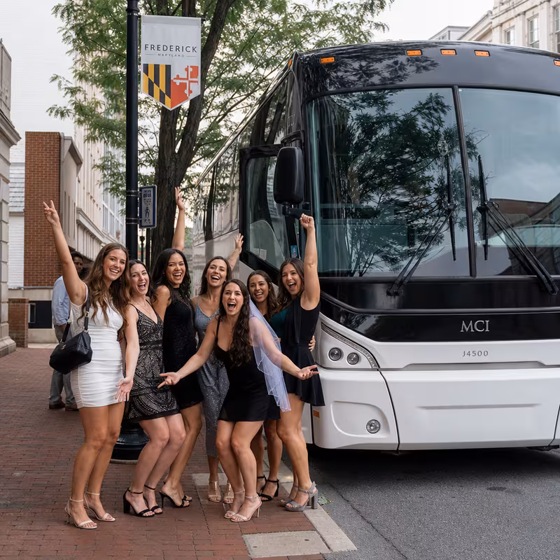 Passengers loading luggage while boarding an Frederick group shuttle