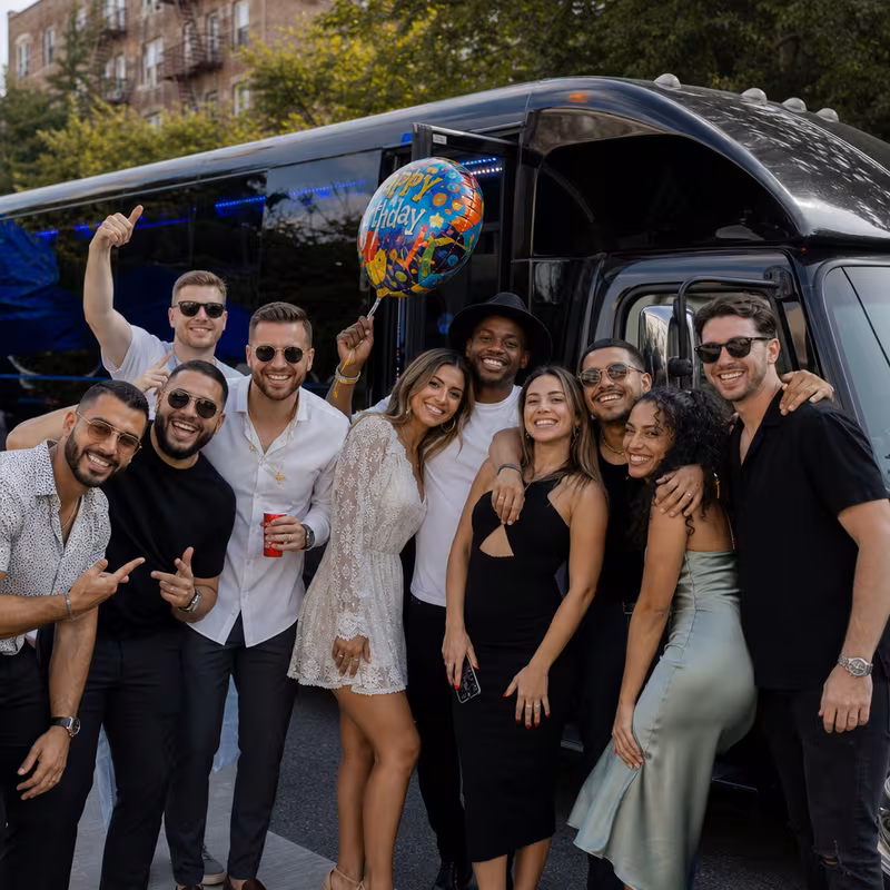Group boarding a white charter bus for Birthday Transportation transportation in Frederick