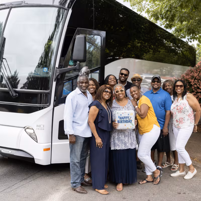 Passengers loading luggage while boarding an Frederick group shuttle