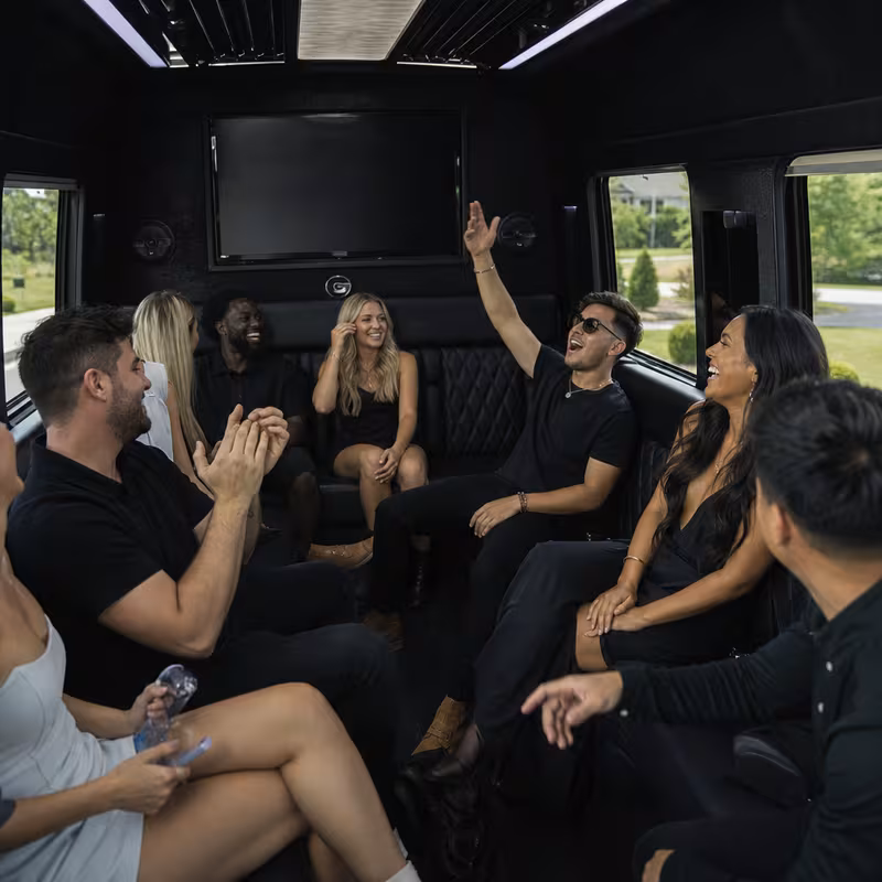Group boarding a white charter bus for Concert Transportation transportation in Frederick