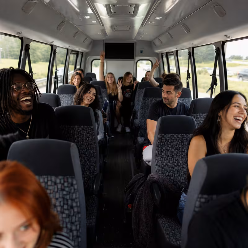 Party bus interior with wraparound leather seating and LED lighting in Frederick