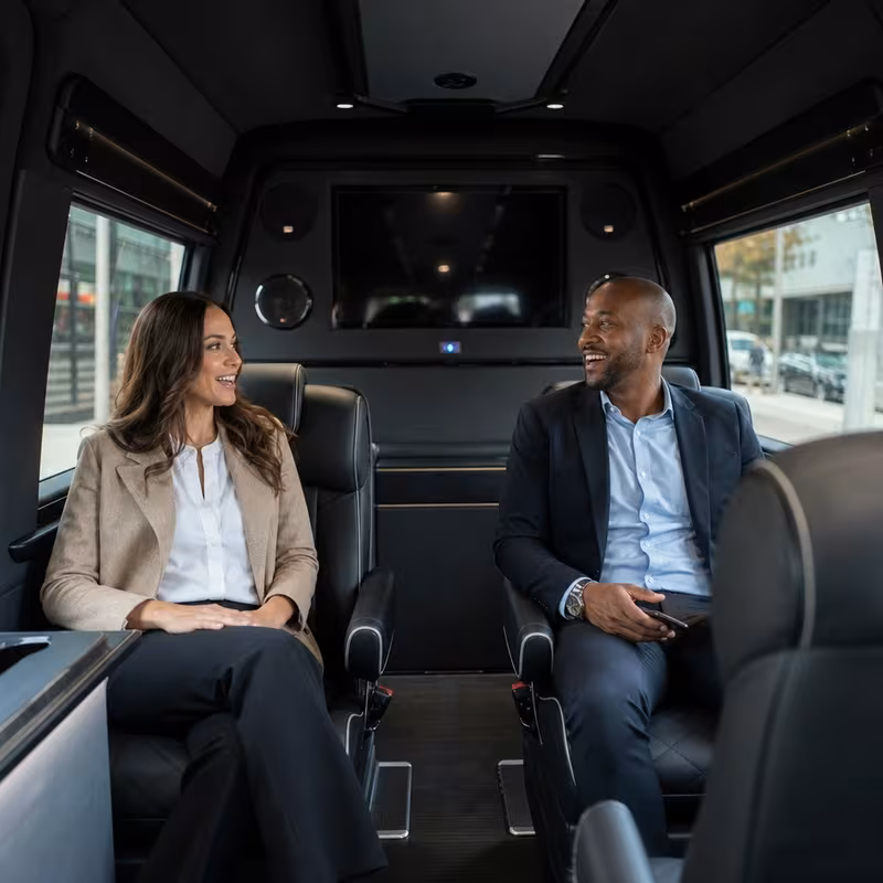 Group boarding a white charter bus for Corporate Transportation transportation in Frederick