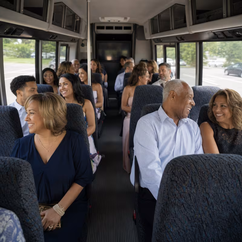 Group boarding a white charter bus for Private Event Transportation transportation in Frederick