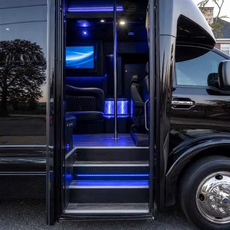 Party bus interior with wraparound leather seating and LED lighting in Frederick