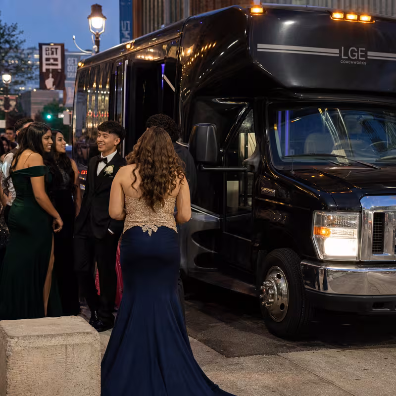 Passengers loading luggage while boarding an Frederick group shuttle