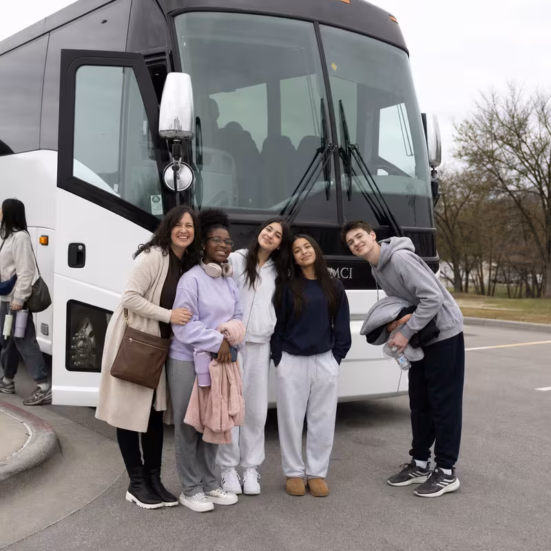 Passengers loading luggage while boarding an Frederick group shuttle