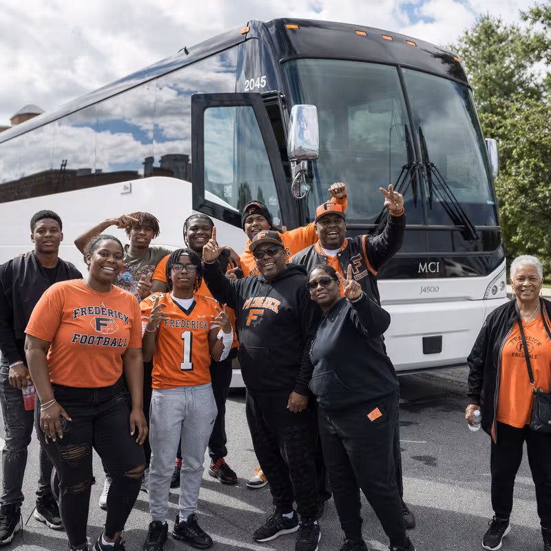 Passengers loading luggage while boarding an Frederick group shuttle