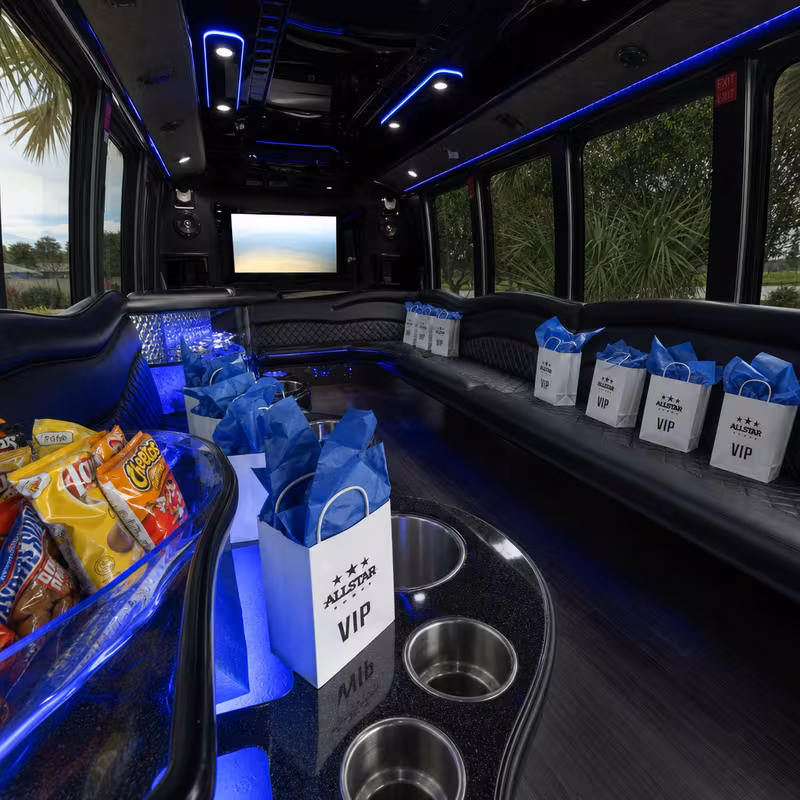 Party bus interior with wraparound leather seating and LED lighting in Frederick