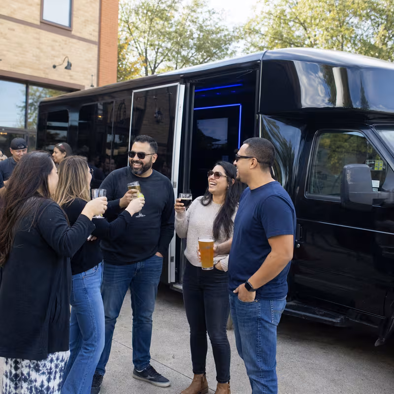Passengers loading luggage while boarding an Frederick group shuttle